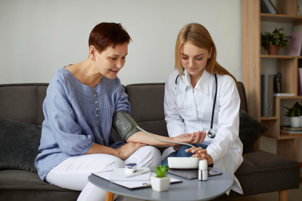 Healthcare professional checking a woman's blood pressure